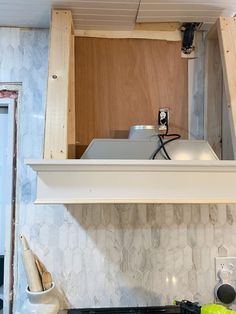 a stove top oven sitting inside of a kitchen under construction