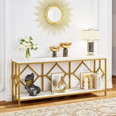 a white and gold console table with vases on it in front of a mirror