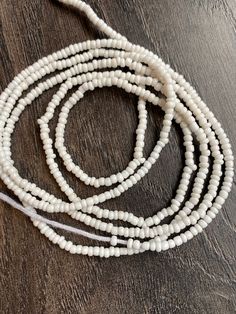 These beads come in 3 piece and are tie ons, they are 45"- 52" long and self adjustable based on your waist size. ★ Please note, the Bead option you pick is exactly what you'll receive. ★ The listed prices are for one strand each. For multiple strands you'll have to indicate from the quantity section in your cart. ﻿★★★★ ALL SALES ARE FINAL. THERE ARE NO EXCHANGES OR RETURNS★★★★ Uses of Waist beads ★ Cultural and Spiritual Reasons ★Waist beads as ornaments as well as for symbolic adornment, ★ whi Adjustable White Waist Beads For Festival, Adjustable White Waist Beads With Tiny Beads, Adjustable White Beaded Lariat Necklace, White Adjustable Lariat Beaded Necklace, Adjustable White Bohemian Waist Beads, Adjustable White Waist Beads With Spacer Beads, White Waist Beads, Waist Beads, Waist Size