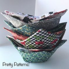 a stack of fabric covered bowls sitting next to each other