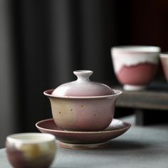 three bowls and a teapot on a table