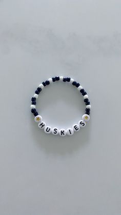 Show your school pride and complete your game day outfit with a custom navy blue and white beaded bracelet for the University of Connecticut! Cheap White Beaded Bracelets For Game Day, Customizable Casual Blue Jewelry, Casual Blue Customizable Jewelry, Casual Customizable Blue Jewelry, College Beaded Bracelets, White Beaded Bracelets For Friendship, Sporty White Beaded Bracelets For Friendship, Sporty White Jewelry For Game Day, School Spirit White Jewelry As Gift