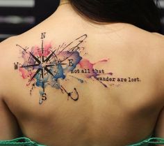 the back of a woman's shoulder with watercolor tattoos on it