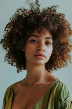 Portrait of a woman with curly hair against a neutral background, conveying calmness or natural beauty. Trendy Bobs, Gorgeous Haircuts, Bob Cut Styles, Layered Pixie