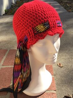 a knitted red hat on top of a mannequin head