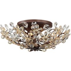 a ceiling light with many crystal flowers on the bottom and brown metal trimmings