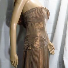 Gorgeous Long Strapless Gown By Vicky Tiel. A Rare Find! The Color Is A Gold-Silver That Looks Like Rose Gold In The Light. It Has A Long Pleated Skirt And Pleated Accents On The Boned Bodice. Zips Up In Back. Size 10. Measurements Across (Laid Flat): Bust- 16” Waist- 14” Length- 53” Note: There Is A Small Area Near The Back Zipper Where The Fabric Is More Silver Than The Rest Of The Gown. This May Just Be The Fabric Type. (See Photos For Details.) Otherwise This Gown Is In Great Condition. Long Pleated Skirt, Boned Bodice, Pleated Long Skirt, Strapless Gown, Dresses Vintage, Pleated Skirt, Vintage Dresses, Strapless Dress, Bodice