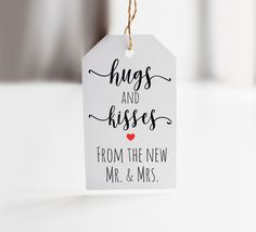 a tag that says hugs and kisses from the new mr & mrs