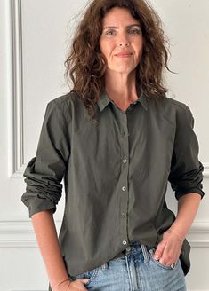 Loose fitting button-down shirt with long sleeves in a dark olive green. back yoke with fine center back pleats. sleeves have pleats cuffs and button plackets. bust darts. slightly flared side seams. straight bottom hem with raw-edged bias tape. garment dyed.    100% cotton. machine wash warm hang to dry. made in france.    t1:    back shoulders:  16.5"  bust: 44.5"  sleeve length: 24.5"  bicep: 15"  cuff: 9.75"  length from front shoulder to hem: 26"  bottom hem circumference: 52"    t2:    back shoulders:  17"  bust: 46"  sleeve length: 25"  bicep: 16"  cuff: 10"  length from front shoulder to hem: 27"  bottom hem circumference: 54"    t3:    back shoulders: 17.5"  bust: 47.5""  sleeve length: 20"  bicep: 17"  cuff: 10.25"  length from front shoulder to hem: 28"  bottom hem circumference Classic Olive Tops For Workwear, Classic Olive Top For Workwear, Olive Button-up Shirt For Work, Green Bohemian Relaxed Fit Shirt, Classic Green Camp Shirt With Button Closure, Olive Button-up Workwear Shirt, Green Camp Shirt With Button Closure, Green Relaxed Fit Shirt With Button Closure, Green Cotton Button-up Camp Shirt