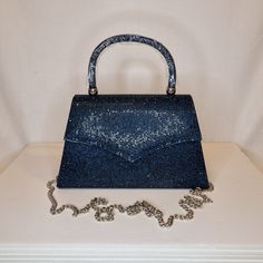 Womens navy blue crystal encrusted luxury evening clutch bag with silver embellishment, metallic satin finish material and magnet front closing top  Can be used with or without long shoulder chain (included) size approx- H 13cm x W 22cm Free Royal Mail delivery is an estimated 3-5 days but this can occasionally be slightly longer which solely on the Royal Mail side. We do offer guaranteed next day delivery but please contact us prior to ordering as this would incur a small upgraded shipping charge. We also offer WORLDWIDE shipping - please contact us for more info 💕🌍 Blue Top Handle Clutch For Formal Occasions, Elegant Blue Clutch With Top Handle, Elegant Blue Top Handle Clutch, Blue Rhinestone Clutch For Party, Crystal-embellished Top Handle Evening Bag, Crystal Embellished Top Handle Evening Bag, Silver Top Handle Evening Bag For Night Out, Blue Evening Bag With Rhinestones, Blue Rhinestone Evening Bag For Party