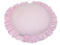 a pink round pillow with ruffles on the bottom and sides, in front of a white background