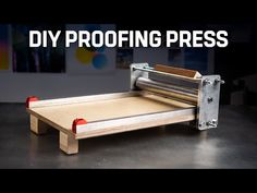 a machine that is sitting on top of a table with the words diy proofing press