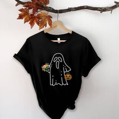 Halloween Ghost Shirt, Halloween Party Shirt, Floral Ghost Shirt, Autumn Shirt, Trick or Treat Shirt, Cute Ghost, Halloween Pumpkin Gift TEE INFORMATION: This t-shirt is soft and lightweight, with the right amount of stretch. It's comfortable and flattering! **Sizing is unisex** Fabric is pre-shrunk 100% combed and ring-spun cotton Black Long Sleeve T-shirt For Costume Party, Novelty Black Short Sleeve Shirt, Halloween Horror Long Sleeve T-shirt, Pre-shrunk Long Sleeve Halloween Shirt, Spooky Black Tops For Costume Party, Black Horror Shirt For Halloween, Black Shirt For Halloween Costume Party, Black Long Sleeve Halloween Shirt, Black Tops For Halloween Costume Party