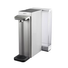 a water dispenser sitting on top of a white counter next to a trash can