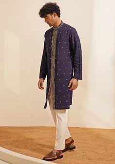 Featuring an elegant Navy Blue Kurta Set, this ensemble includes a button-down kurta designed with a Chinese collar and a hidden placket. The hand-embroidered details on the Kurta add a touch of grace and sophistication. Teamed with elegant white pants, this kurta set combines traditional elegance with contemporary style. Perfect for special occasions like Mehendi or Sangeet. Composition : Chanderi Silk Care: Dry Clean Only and Vacuum Storage This product can be customized for sleeves, length and colour Delivery : 4-6 weeks as the product is hand crafted. Check Size Guide or choose MySize for free customisation (All Sizes above XL can be made at 15% additional cost) For more information and sizes please contact fabiliciousfashion@gmail.com or visit our Copenhagen studio. About the Designer Luxury Casual Blue Kurta, Ceremonial Fitted Blue Kurta, Luxury Blue Semi-formal Kurta, Navy Blue Kurta, Blue Semi-stitched Silk Kurta, Vacuum Storage, Chinese Collar, Indian Wedding Wear, Kurta Designs