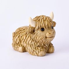 a small statue of a yak with horns on it's head and eyes