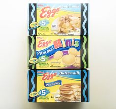 three boxes of egg muffins stacked on top of each other in front of a white wall