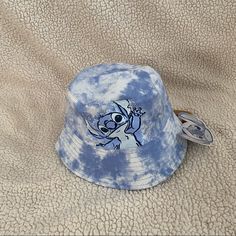 a blue and white tie dye bucket hat with an image of a cartoon character on it