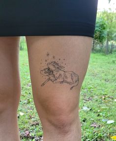 a woman's legs with a tattoo of a horse and stars on the side