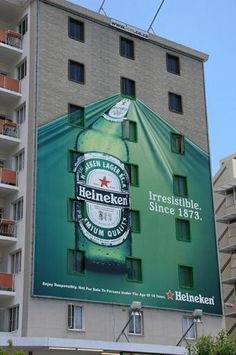 an advertisement for heineken beer on the side of a building