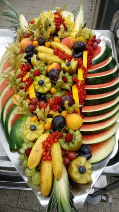 a platter filled with lots of different types of fruit on top of each other