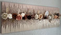 a wall hanging with flowers and sequins on it's side in a room