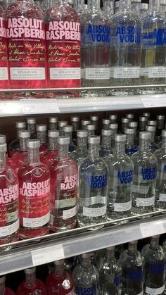 bottles of absolut vodka on display in a store