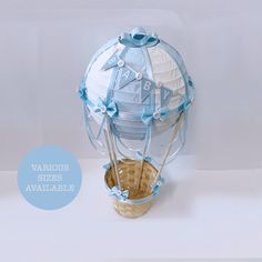 a blue and white hot air balloon sitting on top of a basket