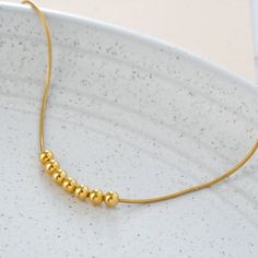 "Hello, we handcraft all of our jewelry ourselves and we will ship fast. We design long lasting pieces for your everyday apparel. This necklace is part of the minimalism collection. you or your loved one can look beautiful with this necklace. * Beads and chain Material: Vermeil Gold (24k Gold over Solid Sterling Silver) * Beads Diameter: 4 mm or 0.16\" Approximately * Length of Chain: Choose the length * Ready to Ship in 2 business days * Made in the USA Keep all your jewelry in an enclosed and Metal Necklaces With Spacer Beads For Gift, Metal Necklace With Spacer Beads For Gift, Adjustable Clavicle Chain Necklace With Round Beads, Adjustable Gold Charm Necklaces With Round Beads, Minimalist Adjustable Chain Necklace With Round Beads, Minimalist Adjustable Round Bead Chain Necklace, Elegant Metal Necklaces With Spacer Beads, Minimalist Beaded Necklaces With Adjustable Chain, Minimalist Beaded Chain Charm Necklaces For Gifts