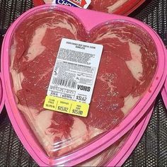 two packages of frozen meat are in the shape of a heart shaped box with a price tag on it