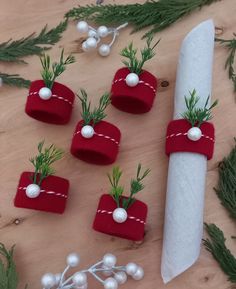 christmas decorations made out of toilet paper on a wooden table with a knife and other items