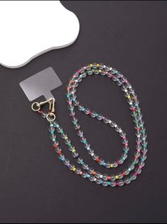 a colorful beaded lanyard with a mirror on the side and a keychain attached to it