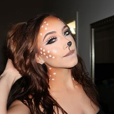 This enchanting deer makeup look combines natural beauty with a touch of whimsy. The soft brown tones and white spots create an ethereal, woodland creature effect that’s perfect for a fun Halloween makeup idea. The doe-like eyes, accentuated by dramatic eyeliner and long lashes, add to the overall charm of this look.   Photo credit by: @thtgirlhannahhh Makeup Looks Halloween Cute, Cute Makeup Ideas For Halloween, Halloween Doe Makeup, Easy Animal Halloween Makeup, Animal Face Paintings Adult, Reindeer Halloween Makeup, Non Scary Halloween Makeup