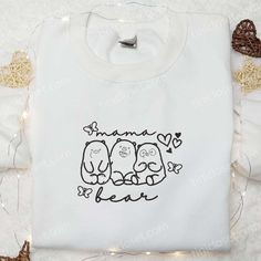 Mama Bear We Bare Bears Embroidered Shirt, Mother’s Day Embroidered Hoodie, Best Gift For Mom Welcome to Tinicloset, your one-stop destination for custom embroidered apparel that adds a touch of personality to your wardrobe. At Tinicloset, we specialize in creating unique and charming pieces that capture the essence of individuality and style. As you step into our store, you’re greeted by a vibrant display of intricately embroidered shirts, sweatshirts, T-shirts, and hoodies, each te Cute White Embroidered Hoodie, Embroidered Apparel, Best Gift For Mom, Embroidered Shirts, We Bare Bears, Bare Bears, Embroidered Clothes, Embroidered Hoodie, Picture This