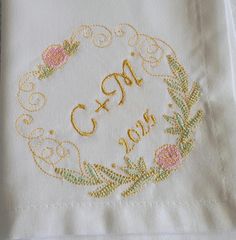 embroidered monogrammed wedding handkerchief on white linen with gold thread and pink flower design