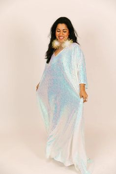 Be the life of the party in this long sequin caftan! This show-stopping caftan is adorned with shimmering sequins that will catch the light and turn heads. With a flowy, relaxed fit, it combines style and comfort. The long length ensures you'll bring the fashion drama, while the sequins add a touch of glamour to your look. These comfortable sequins on mesh are ulined for maximum breeze. Festive Sequined Maxi Kaftan, Sequined Long Sleeve Evening Kaftan, Glamorous Flowy Maxi Dress, Summer Festive Sequined Kaftan, Festive Floor-length Sequined Kaftan, Summer Party Sequined Kaftan, Summer Party Sequin Kaftan, Summer Party Kaftan With Sequins, Spring Party Kaftan With Sequins