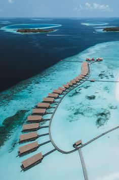 an aerial view of a resort on the water with overwater walkways leading to it