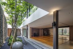 the inside of a modern house with wood floors and large glass windows on the wall