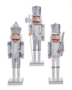 three metal nutcrackers are standing next to each other on a white background