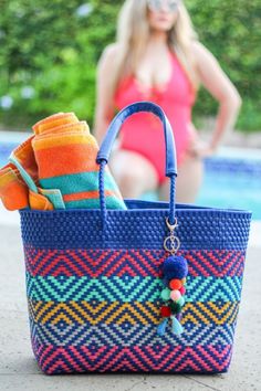 These premium tote bags have bright vibrant colors and are the perfect addition to your outfit. This bag features a double weaving technique requiring more material visible in the cross color detailed pattern. It also makes the bag extremely sturdy. The bag features inner lining, pockets, closure, vinyl handles, and a handcrafted pompom. Vacation Shoulder Bag With Removable Pouch, Vacation Bucket Satchel With Detachable Handle, Summer Bags With Detachable Handle For Shopping, Summer Shopping Bags With Detachable Handle, Travel Beach Tote Bag With Detachable Handle, Travel Beach Bag Tote With Detachable Handle, Travel Beach Bag With Detachable Handle, Tote Shape, Travel Beach Bag With Detachable Handle, Summer Tote Bag With Detachable Handle