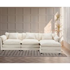 a living room with a white couch and rug