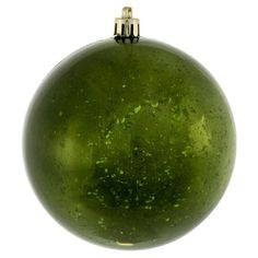 a green ball ornament hanging from a metal hook on a white background with clippings