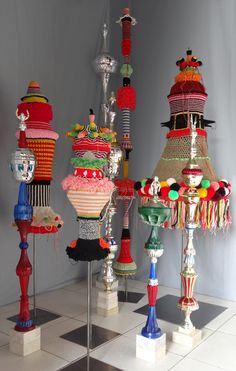 a group of colorful lamps sitting on top of a checkered floor