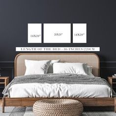 a bed with white sheets and pillows in a room that has black walls, two pictures on the wall