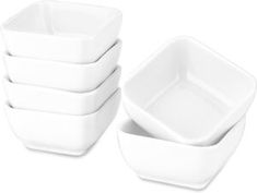 four white square bowls stacked on top of each other in front of a white background