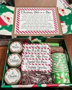 a box filled with lots of christmas treats next to some paper plates and napkins