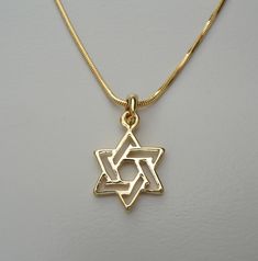 "Kabbalah jewelry for Love, Hope and Prayer  - Classic Gold Plated plain \"Magen David\" Pendant with from HolyLand Jerusalem  ** comes with gift bag.   This Star of David pendant is a plated silver charm that packs a powerful presence and message. Show pride in Jewish heritage with this plated silver Star of David charm.  This Necklace is quite lovely and a pleasure to have with you always or to give as a special gift.  Special discounts will be given for large quantities, please contact me for Gold Star Of David Jewelry For Anniversary, Nickel-free Star Of David Jewelry Gift, Hallmarked Star Of David Jewelry For Gift, Gold Star Of David Jewelry Gift, Star Of, Prayer Gifts, Judaica Jewelry, Jewish Heritage, Star Of David Pendant