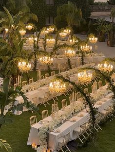 an outdoor wedding setup with white flowers and candles