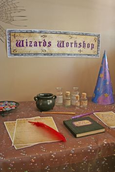 the wizard's workshop table is set up with books, paper and other items