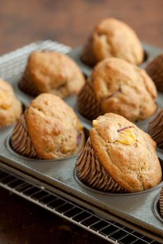 freshly baked muffins sitting on a cooling rack ready to be picked up from the oven